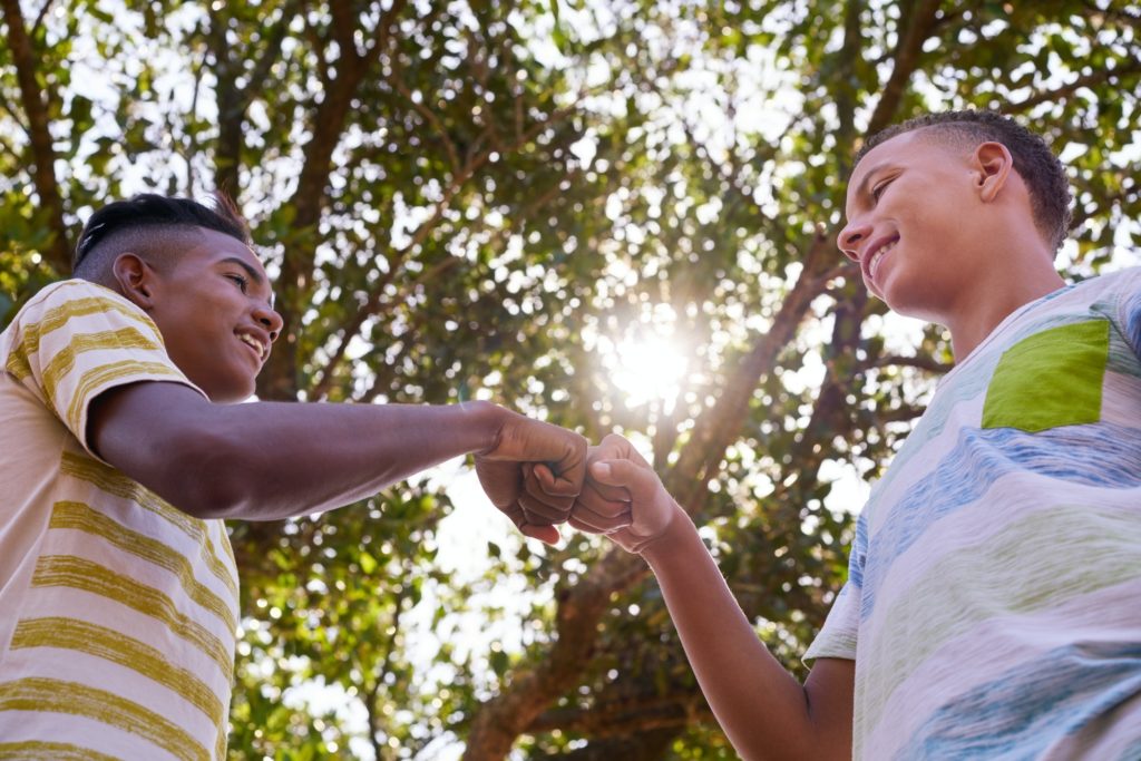 African And Caucasian Boys Joining Hands Against Racism